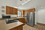The Kitchen with glass top range and Stainless Steel Refrigerator/Freezer