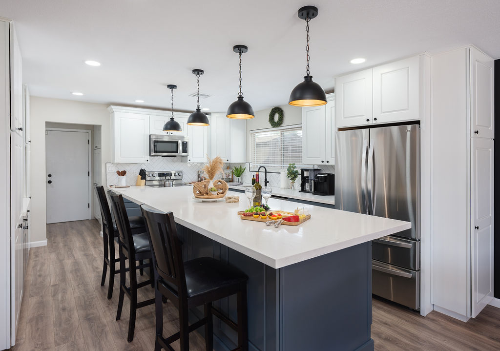 Open concept kitchen with stainless steel appliances, breakfast bar island seating, tons of natural light, and fully stocked with your basic cooking essentials.