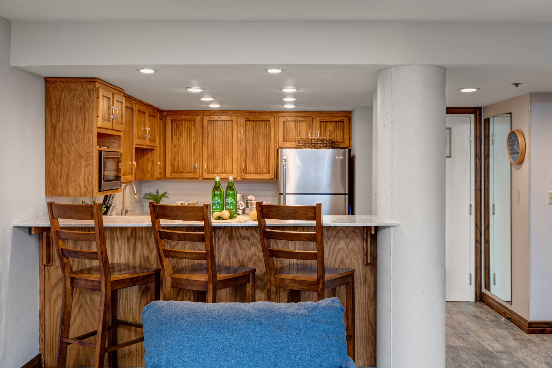 Fully Equipped Kitchen with stone countertops, stainless steel appliances, and bar seating for three