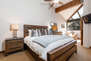 Master Bedroom with king bed, TV, sitting area, and en suite bathroom