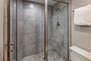 Shared Full Bathroom with tile & glass shower