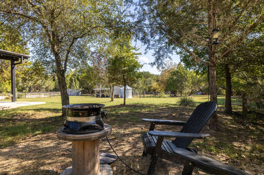 Private yard with adirondack chairs and gas heater