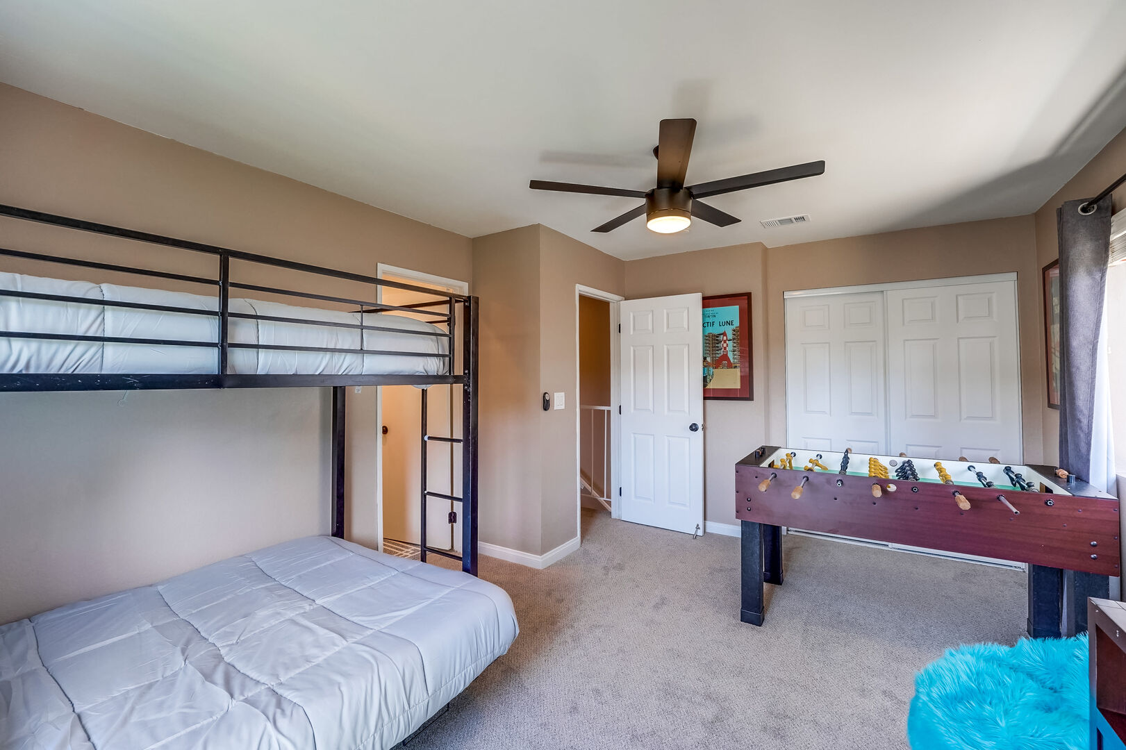 Remote-controlled ceiling fan, bean bag chairs, foosball table, closet and in-suite full bathroom