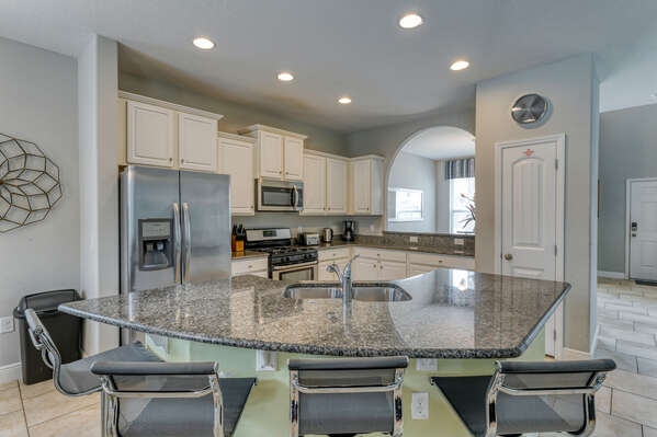 Kitchen showing breakfast bar with seating for 4