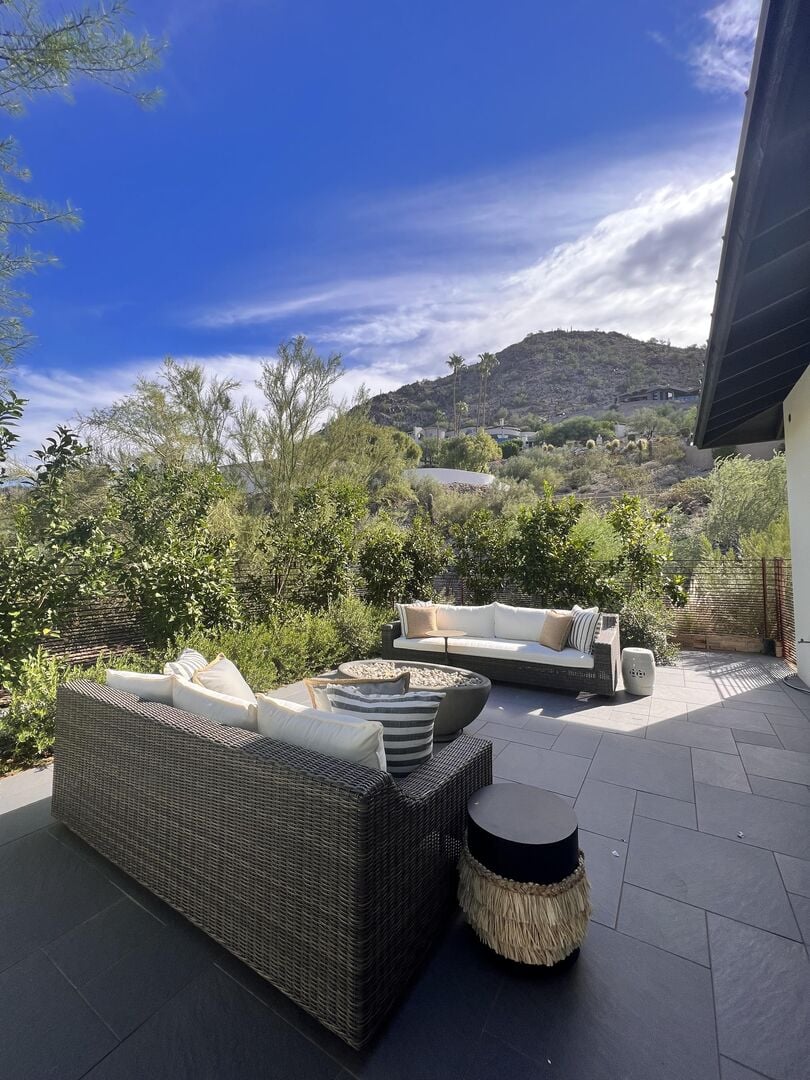 An east-facing perspective from the fire pit and seating area, offering a picturesque view of the mountains.