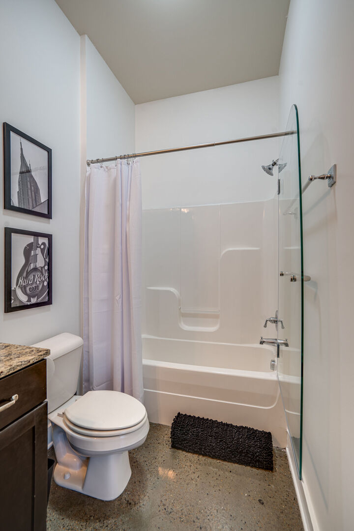 Unit 2: Full bathroom with shower and tub combo.