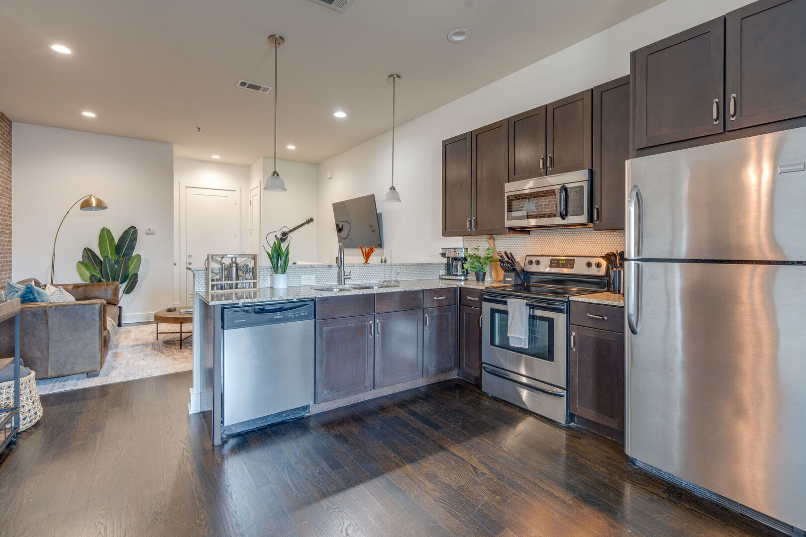 Unit 4: Fully stocked kitchen with basic cooking essentials, stainless steel appliances, granite countertops and breakfast bar seating.