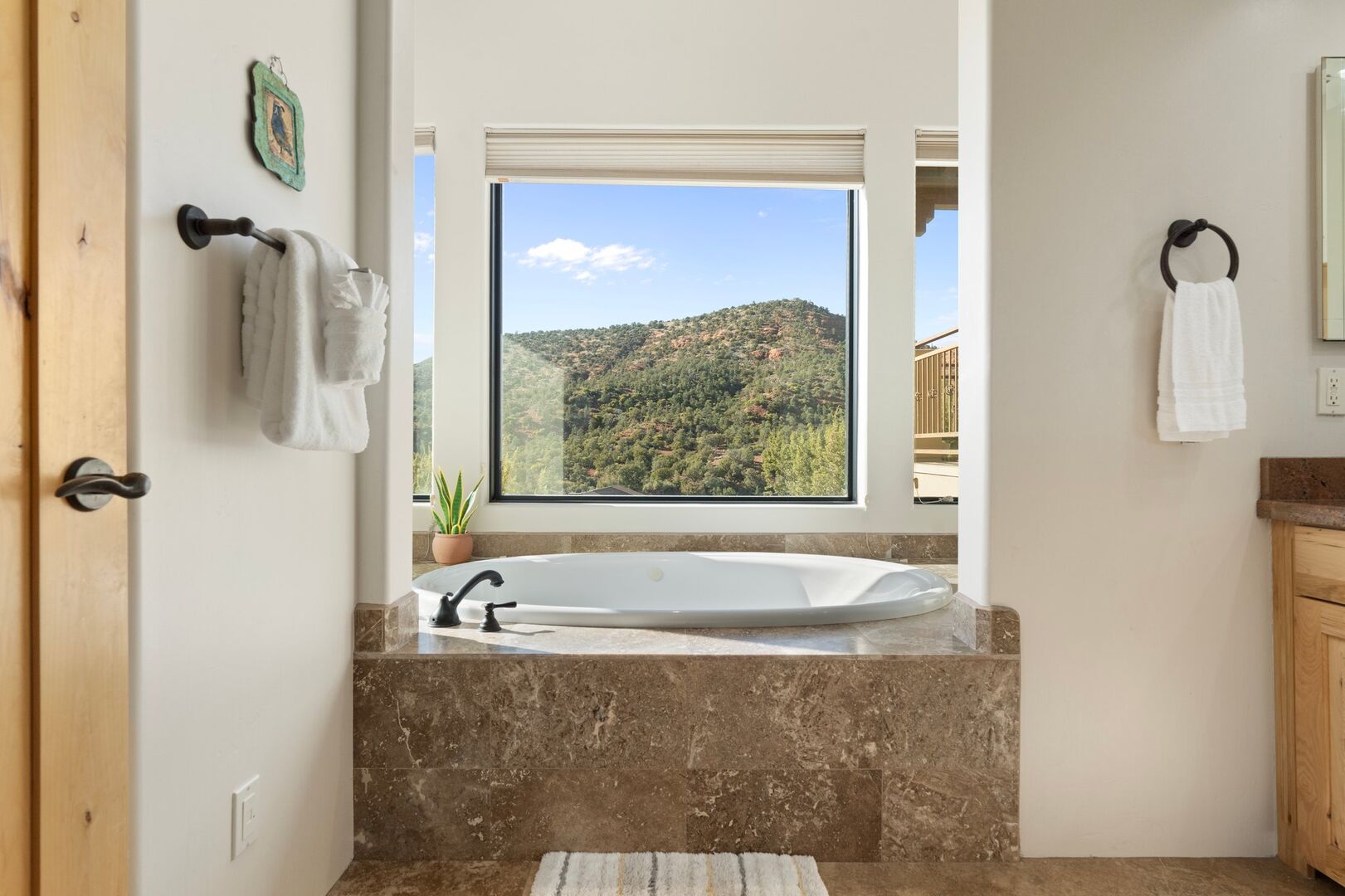 Master En-suite features a luxurious bathroom with a walk-in two-person shower, jacuzzi tub with stunning views, and double sinks.