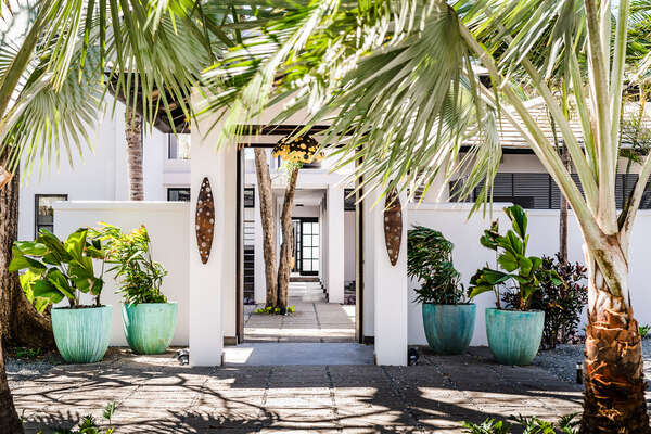 Cascading palms greet you at the villa's main entrance.