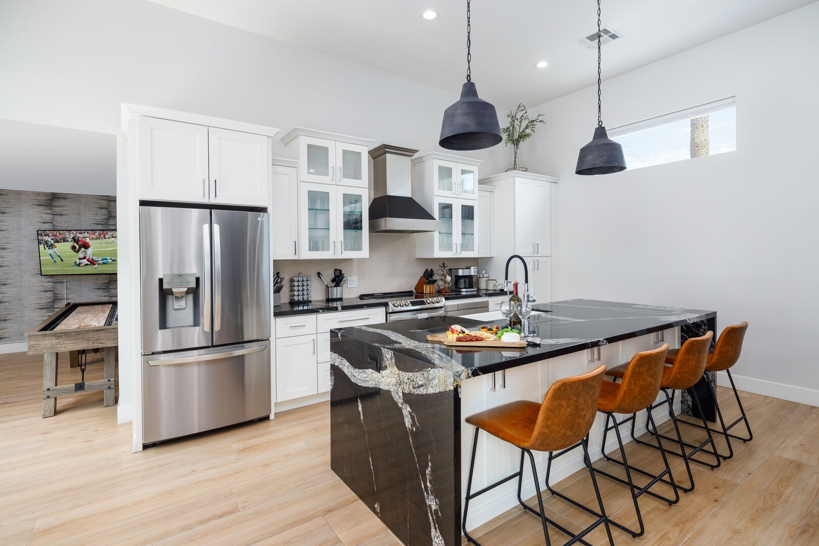 Gourmet style kitchen with stainless steel appliances stocked with your basic cooking essentials. Features large island with breakfast bar seating.