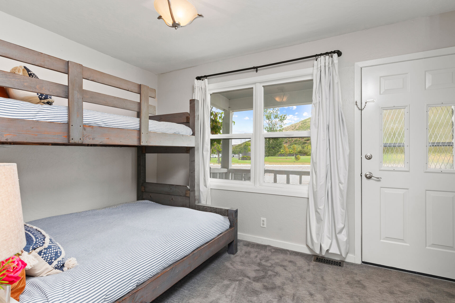 Bedroom 3 with twin over queen bunkbed, private entryway, and full bath access