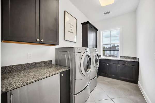 The laundry area is equipped with a washer and a dyer for your convenience.