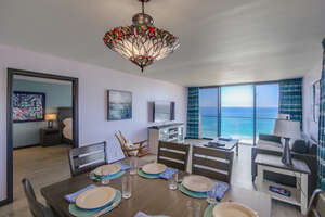 Central dining room for 6 guests to enjoy a meal with the spectacular sunset! View into the master bedroom