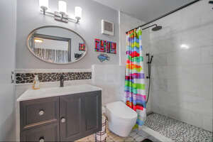 In-suite full bathroom with walk-in shower, rainfall shower head, smart remote-controlled toilet (with bidet!) and vanity