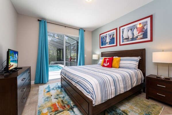 Bedroom 2 master suite with king bed and pool access.