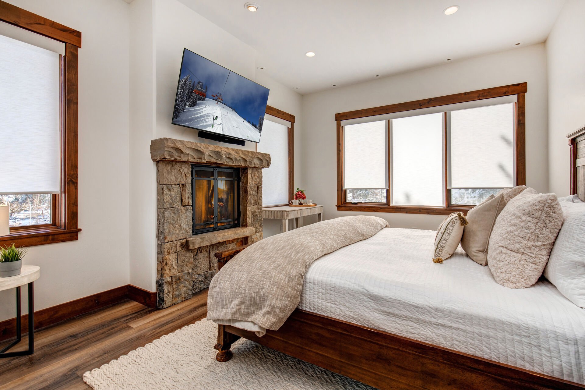 Grand master bedroom with King bed, gas fireplace, Smart TV, a working desk, and en suite bathroom