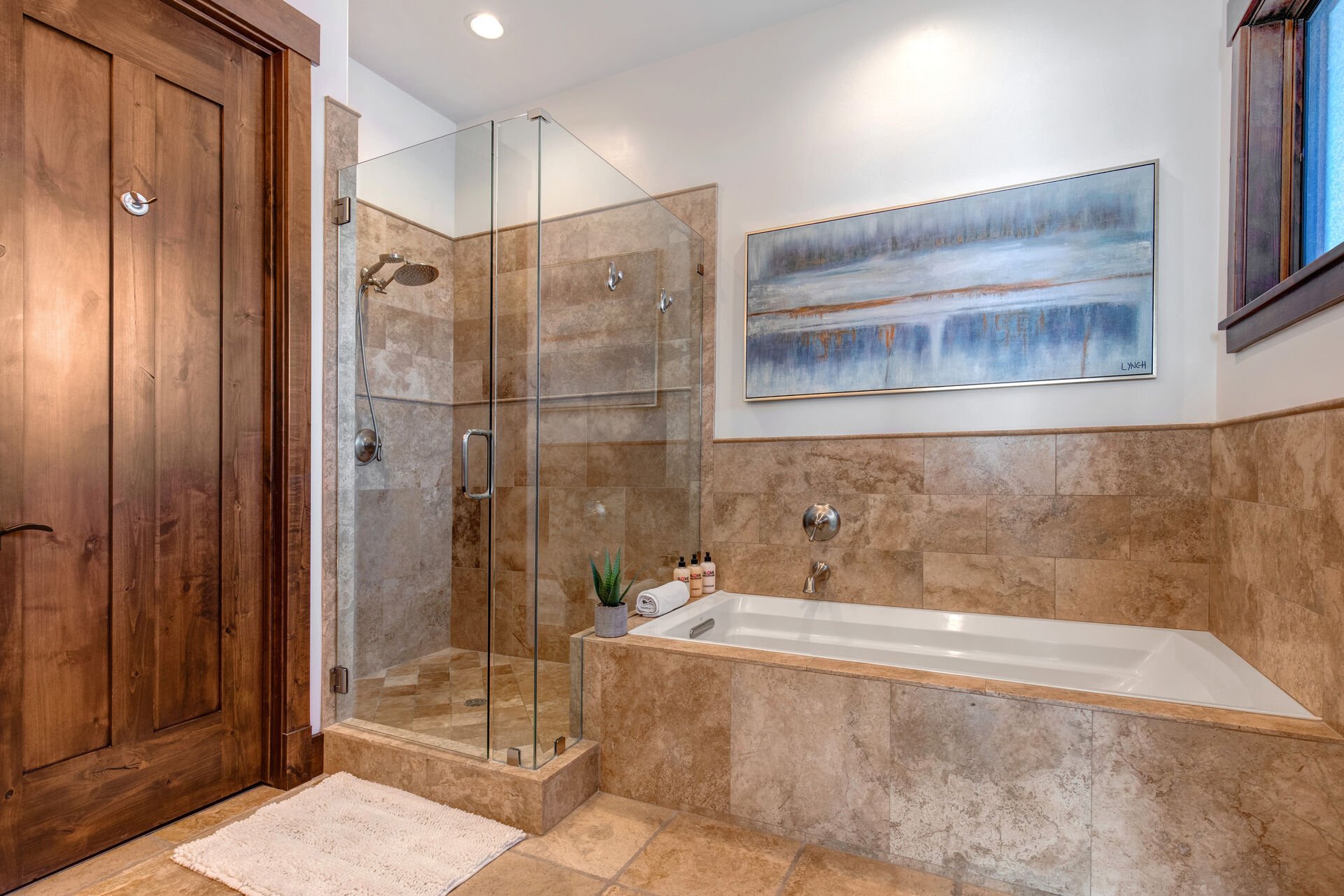 The grand master bath offers dual stone counters sinks, a large tile and glass shower, and jetted soaking tub