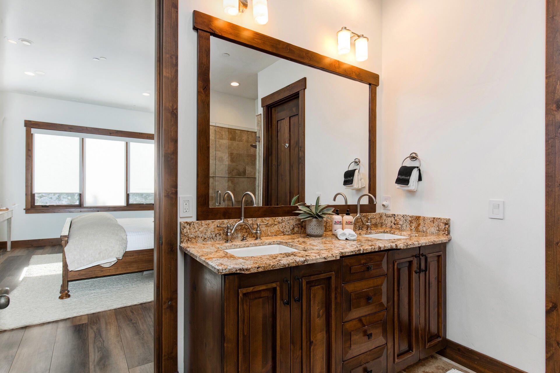 The grand master bath offers dual stone counters sinks, a large tile and glass shower, and jetted soaking tub