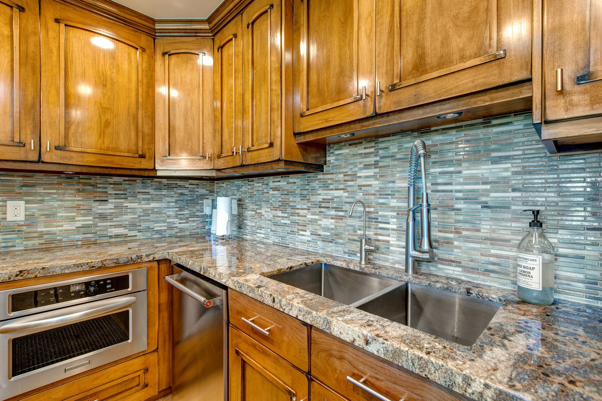 Fully Equipped Kitchen with gorgeous stone countertops, stainless steel appliances - including double ovens - ice maker, and bar seating for three