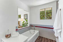 Primary Suite, tub with through views of the ocean via the bedroom.