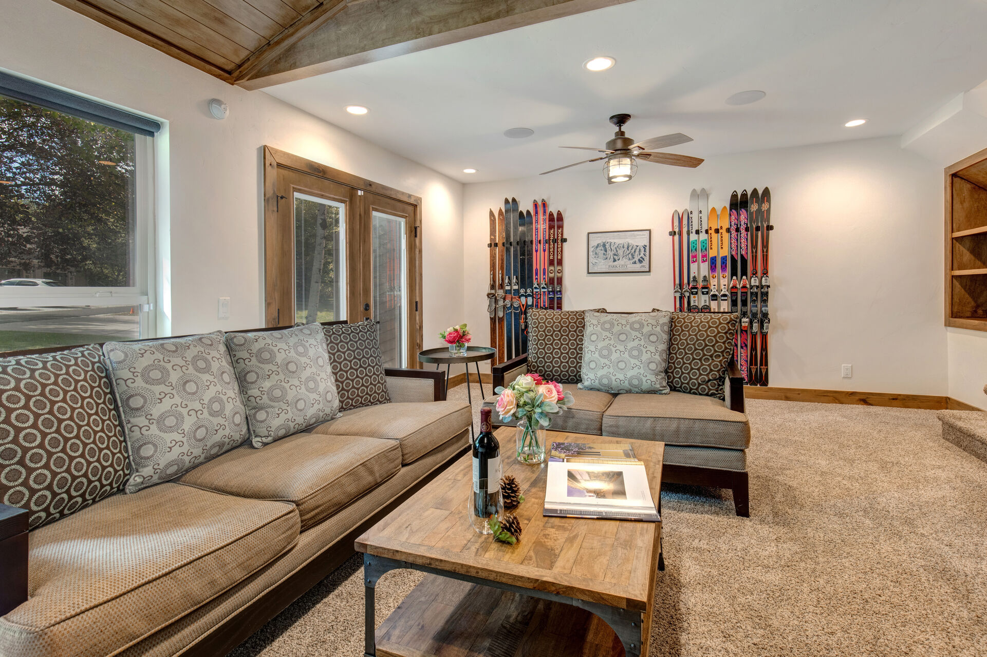 Living Room with cozy gas fireplace, Smart TV, plush furnishings, vaulted ceiling, and patio access.