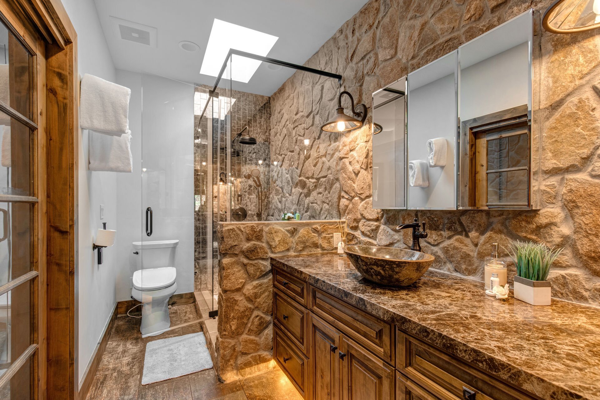 Master Bathroom with gorgeous river-rock detailing and stone and glass shower