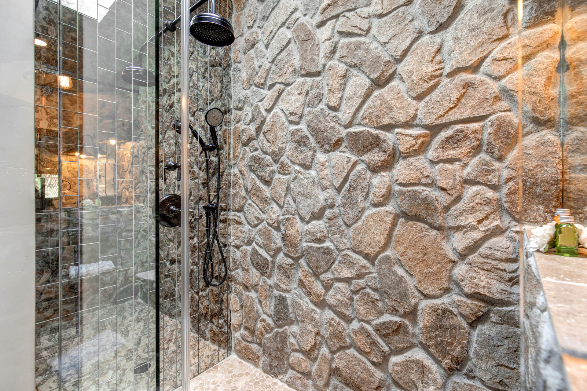 Master Bathroom with gorgeous river-rock detailing and stone and glass shower