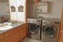 The Washer and Dryer are located in the bathroom with the vanity