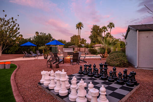Incredible back yard with fire pit, heated pool, hot tub, putting green and chess board