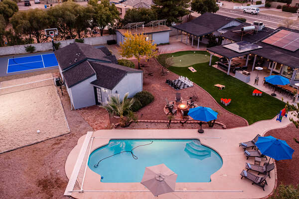 Incredible back yard with Pickleball, volleyball, fire pit, heated pool, hot tub, putting green and chess board