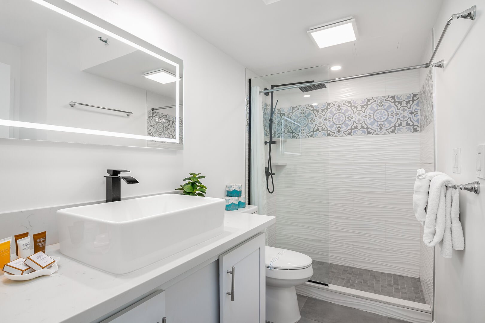 Full bathroom with walk-in shower, and a vanity with cabinet.