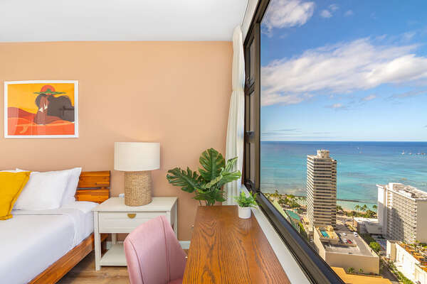 Bedroom with stunning ocean view, dedicated workspace, and a king-size perfect for your relaxation.