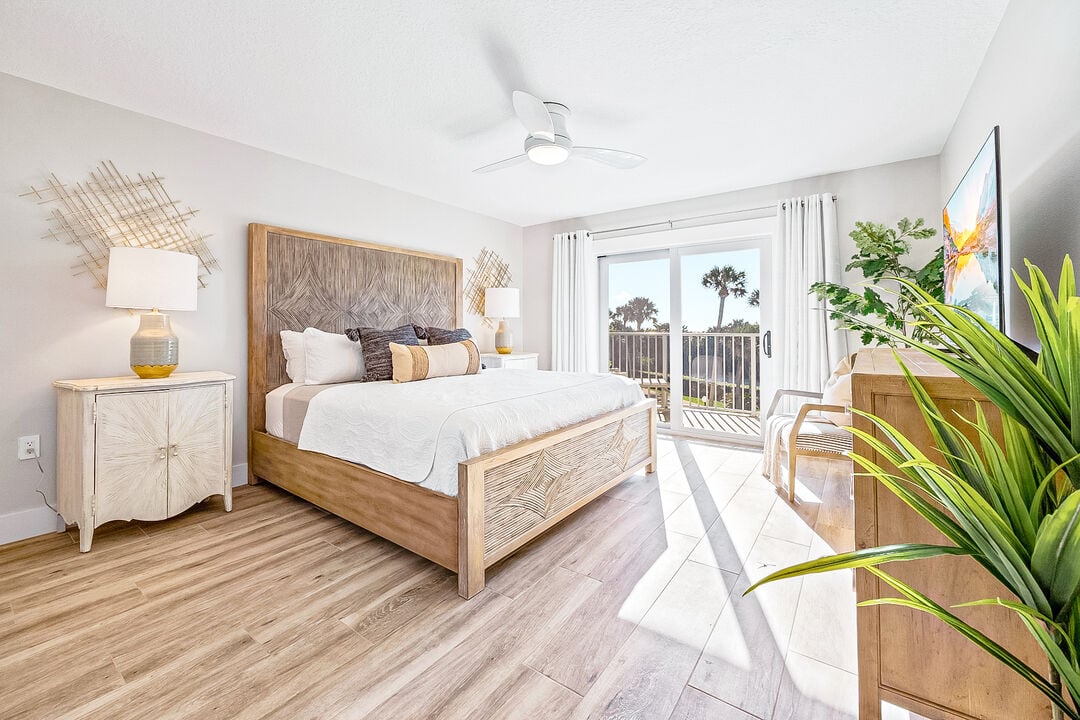 Beautiful master bedroom with a plush king bed and direct balcony access
