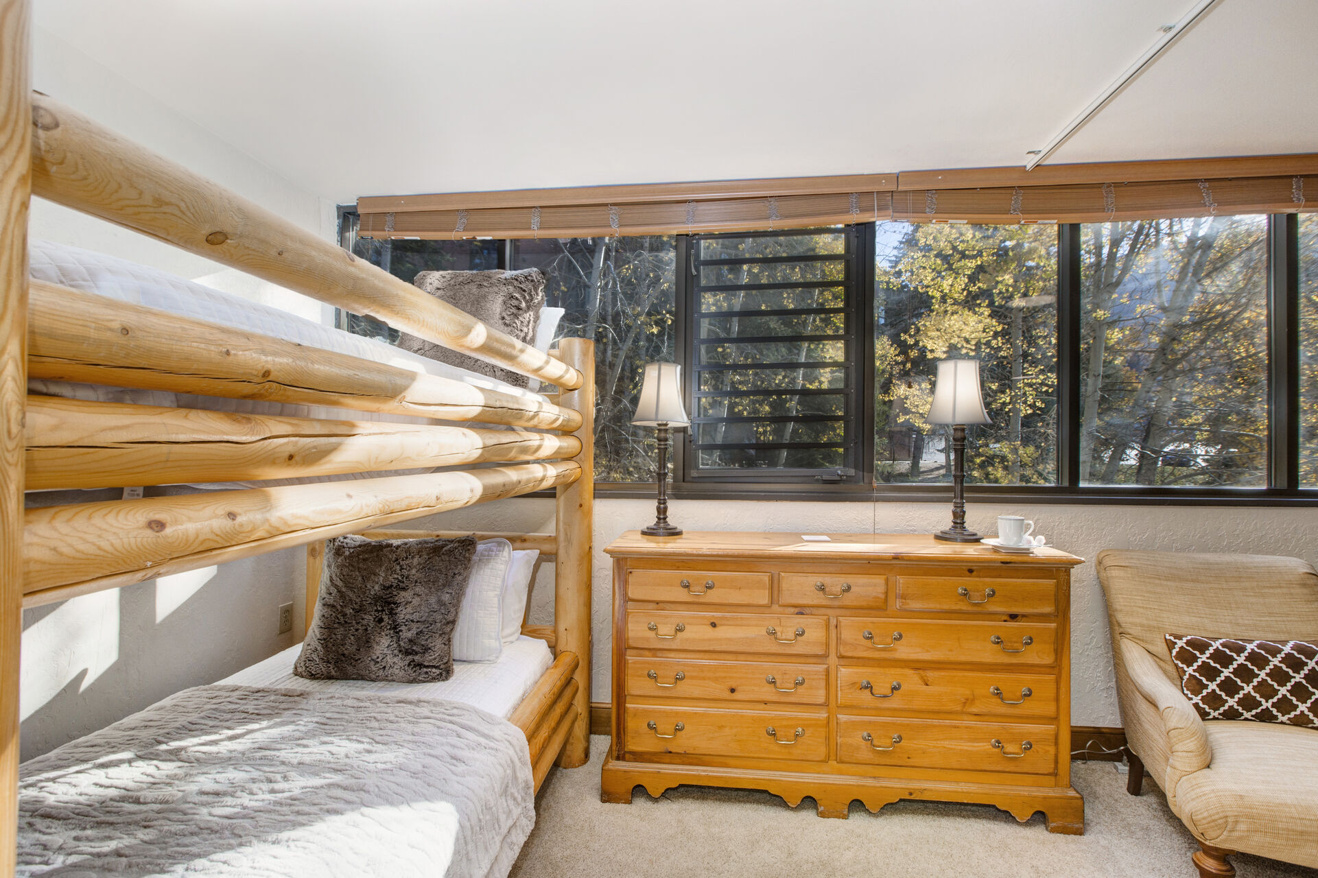 Common Area with twin over twin bunkbed, privacy shade, and full bath access