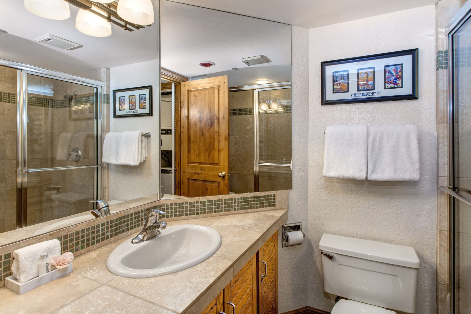 Shared Full Bathroom with large tile and glass shower