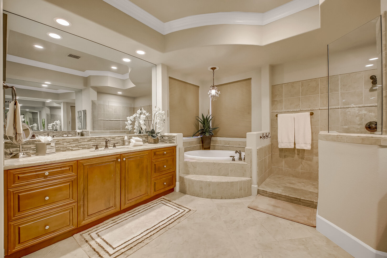 The private en suite bathroom features a soaking tub, tile shower and his and her vanity sinks.