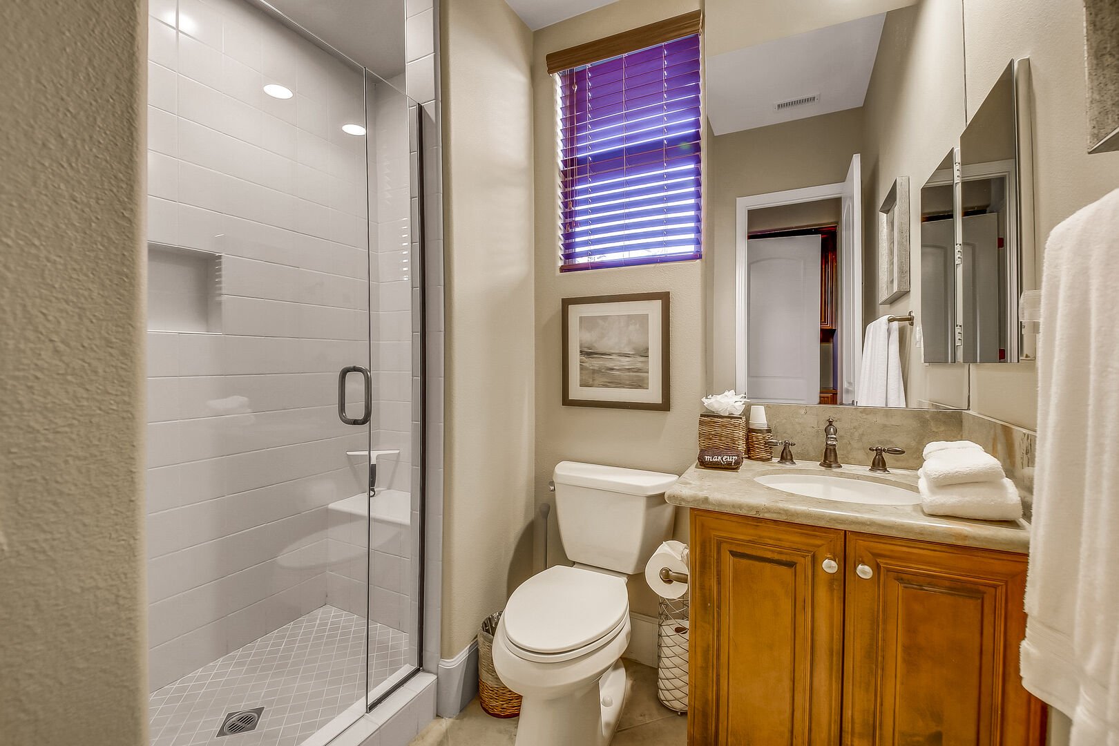 The private en suite bathroom features a tile shower and a vanity sink.
