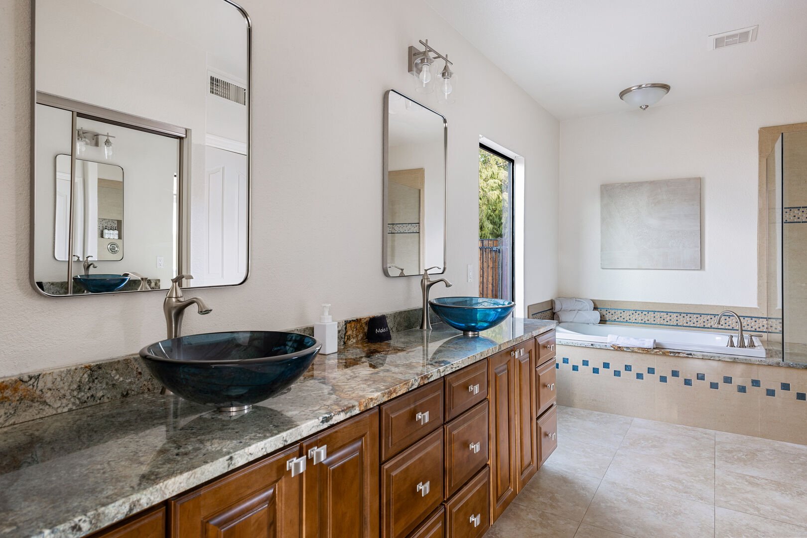 En-suite bathroom with double vanity sinks.