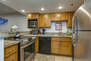 Fully Equipped Kitchen with beautiful stone countertops, stainless steel appliances, and bar seating for four