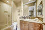 The private en suite bathroom features a tile shower and a vanity sink.