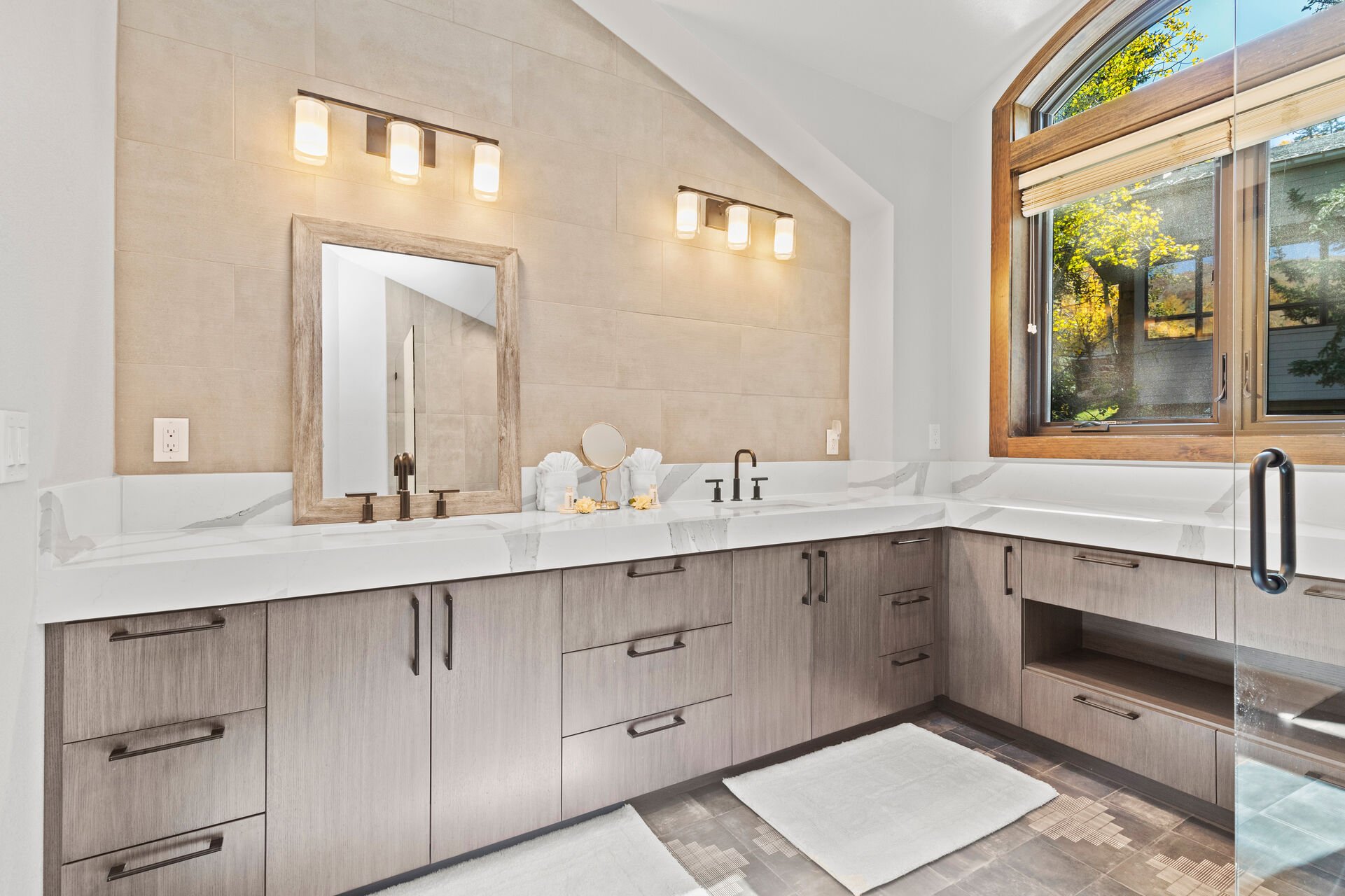 Master Bathroom with stunning wrap-around vanity and large tile and glass shower