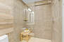 Lower Level shared bath with tile and glass shower