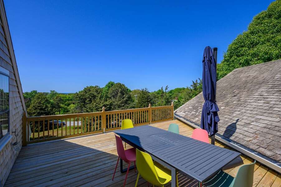 Sunny deck, protectively nestled between the main house and the above-garage Primary bedroom roofline - 5 Quivet Drive East Dennis - La Linda - NEVR