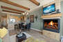 Living Room with sectional, gas fireplace, smart tv, and private deck access