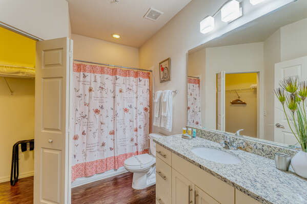 Upstairs master bath with single sink vanity and shower/tub combo