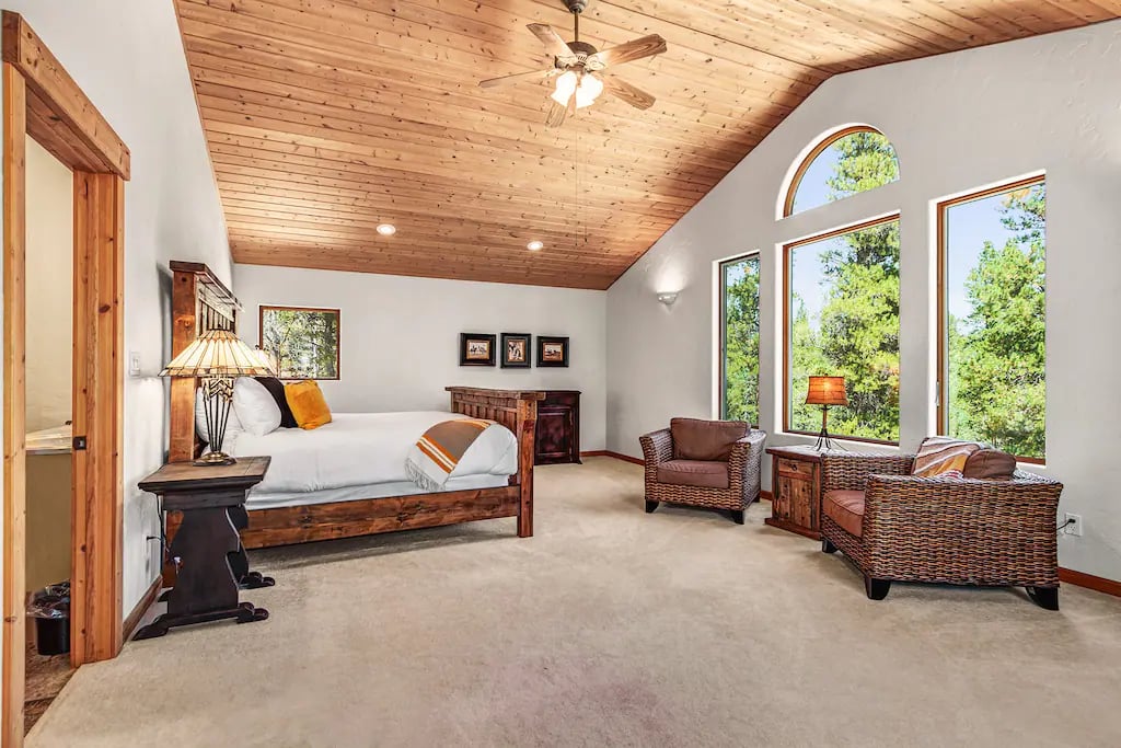 The Main Level master Suite offers vaulted pine ceilings, A luxurious pillow top king bed with luxury linens and bedding.  A work station is available for those working remotely.