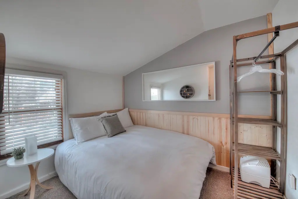 Guest room features a luxury queen bed and premium bedding.