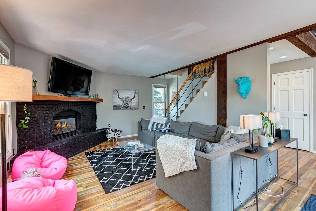 One of two living room areas to host guests while taking in the views, relaxing in comfort and enjoying vacation in style! Gas fireplace, deck access, oversized couch, bean bag chairs and TV