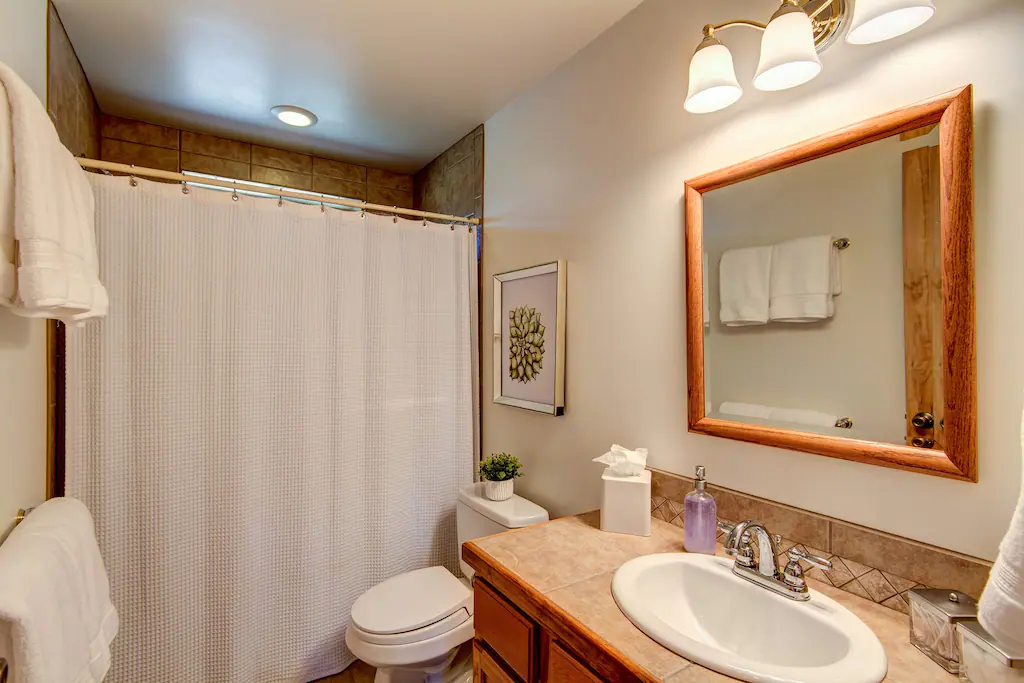 The lower floor bathroom features a full size shower with tiled flooring and vailty.  Our bathrooms are fully stocked with shampoo, conditioner, body wash, TP, lotion, hair dryers, etc.  Everything you need for your vacation!