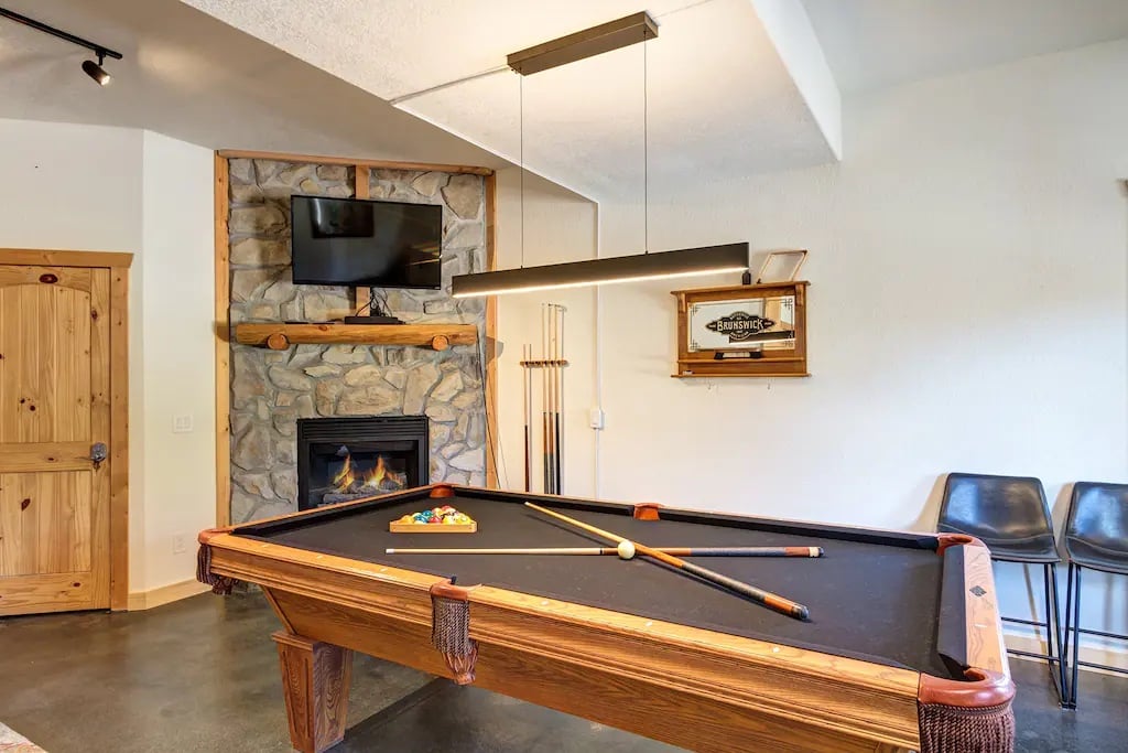Downstairs Pool Table Entertainment Room. With gas fireplace, TV and 3rd guest room, full bathroom and laundry room. All above ground, access to hot tub and driveway
